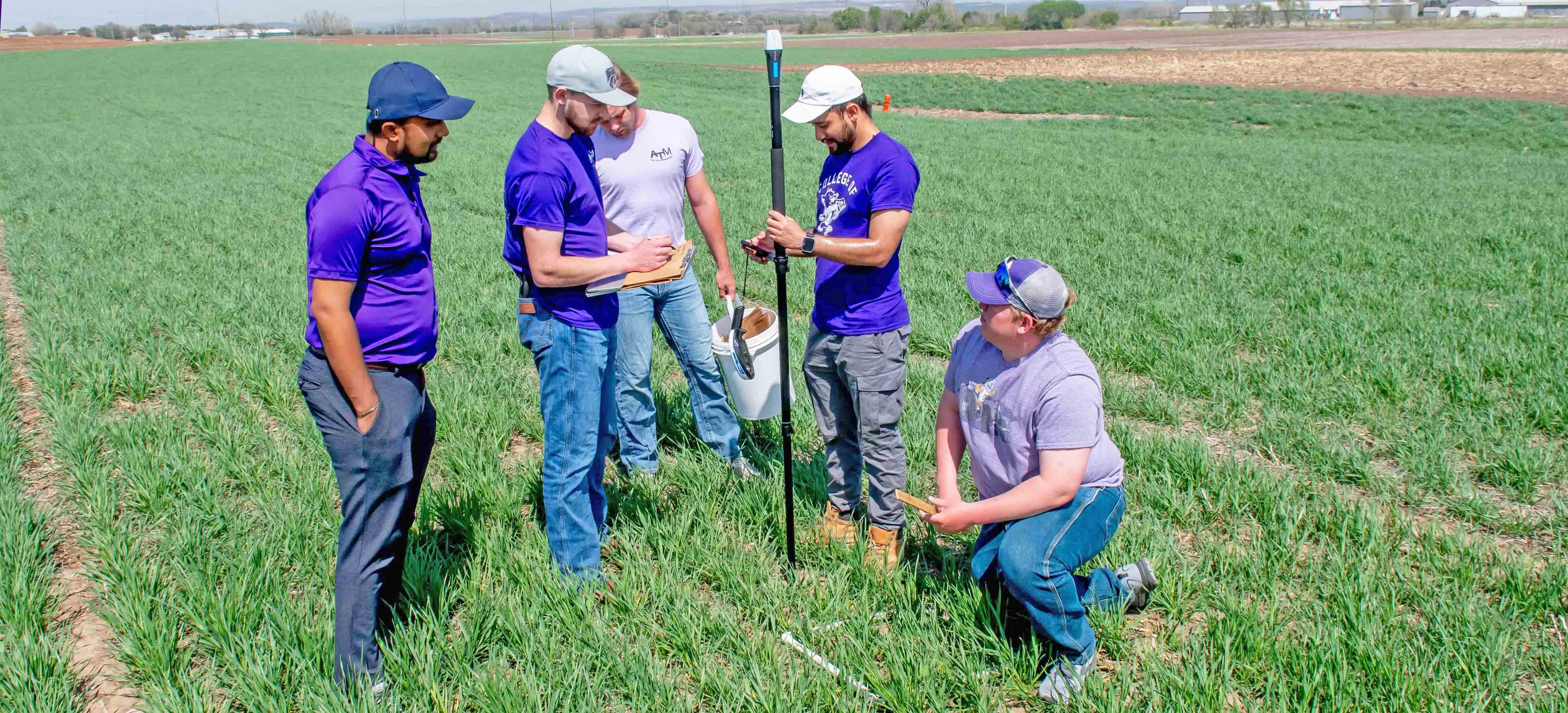 Students standing in wheat field
