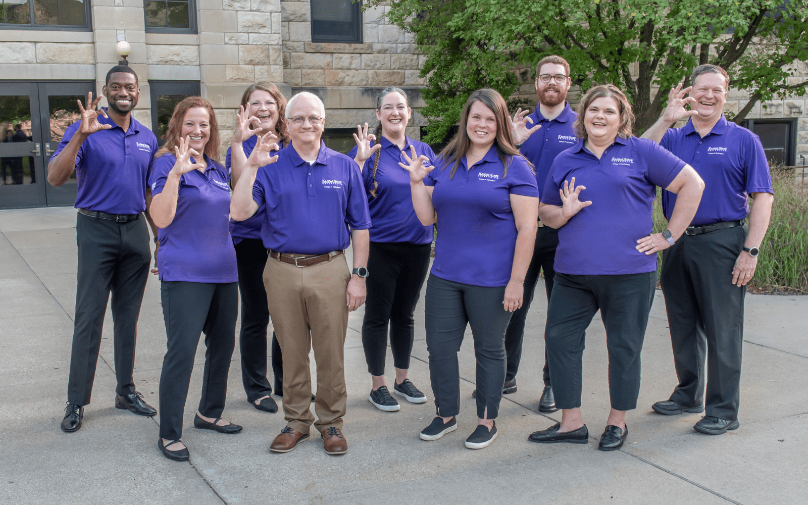 A group of academic advisors in purple polos