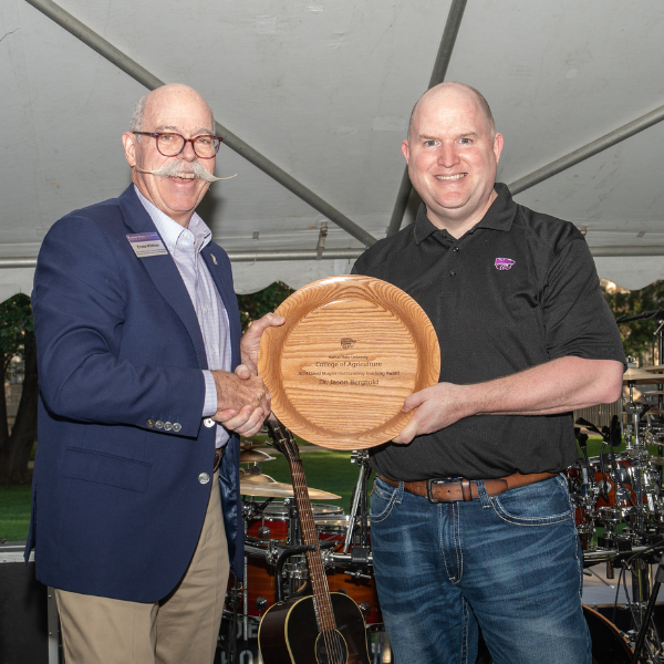 Jason Bergtold receiving award from Dean Minton