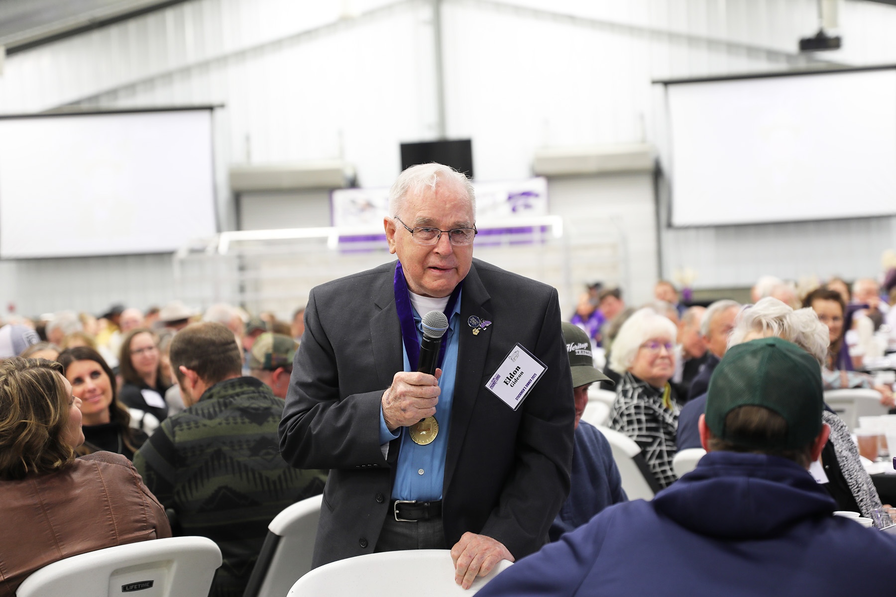 Eldon Gideon speaking with medal