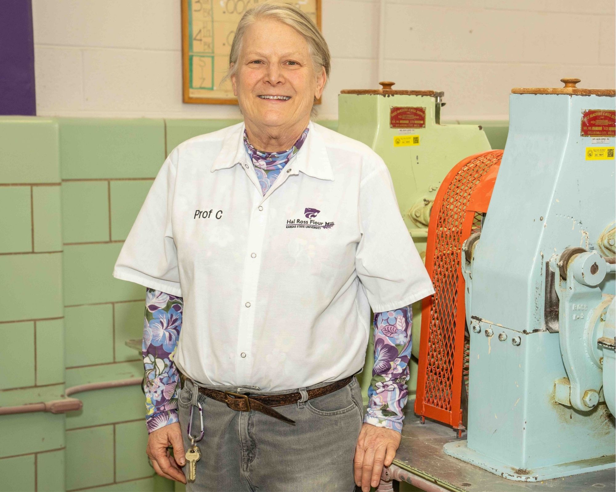 Fran Churchill posing by milling equipment