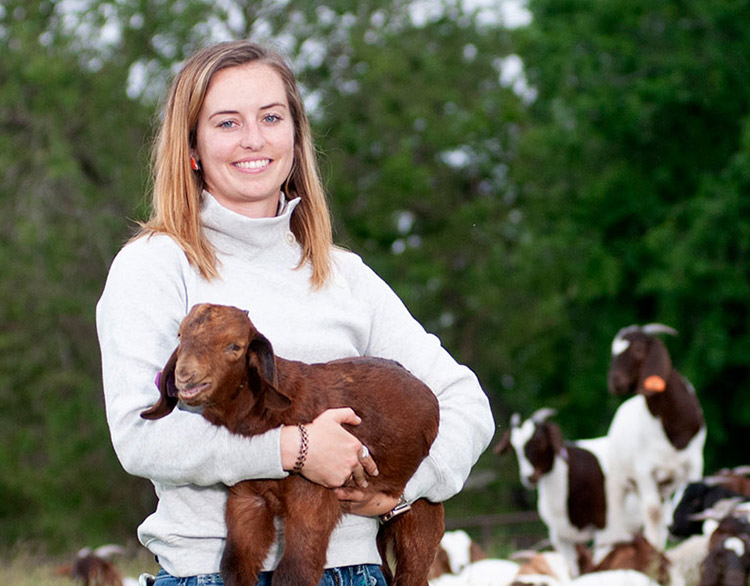 Alison Crane with goats in a field