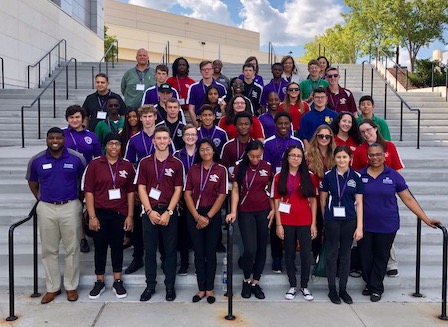 students pose on steps