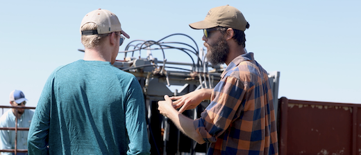 Logan and student discussing equipment